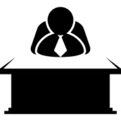 Chief sitting behind a desktop