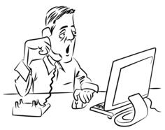 Man talking on the phone while using computer